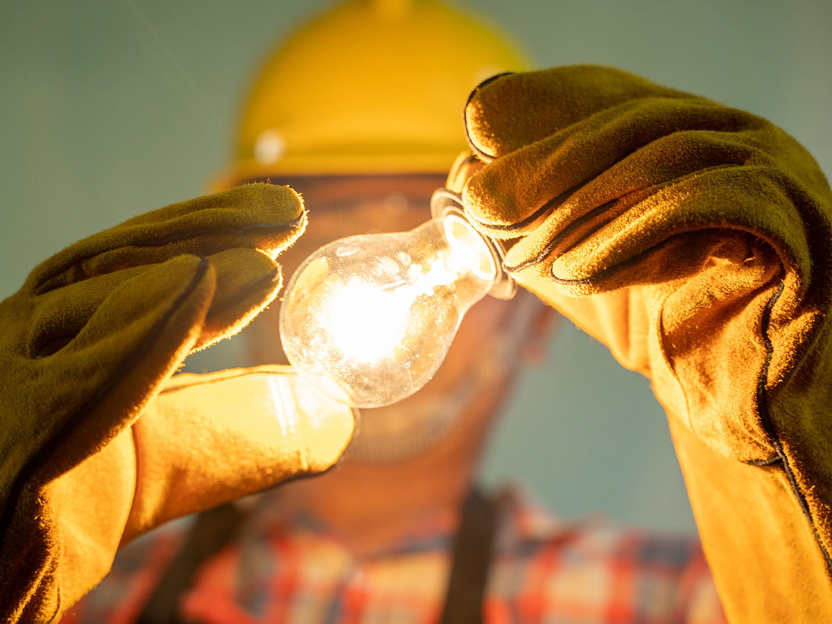 electrician holding a lightbulb