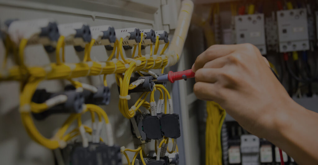Image of an electrician working on a panel