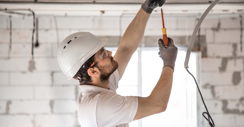 An electrician installing something