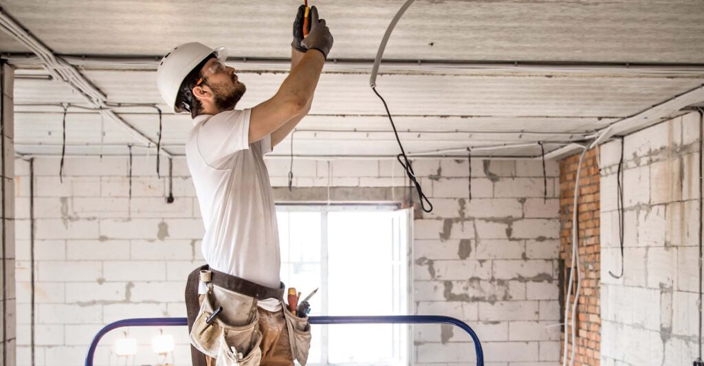 man installing electrical