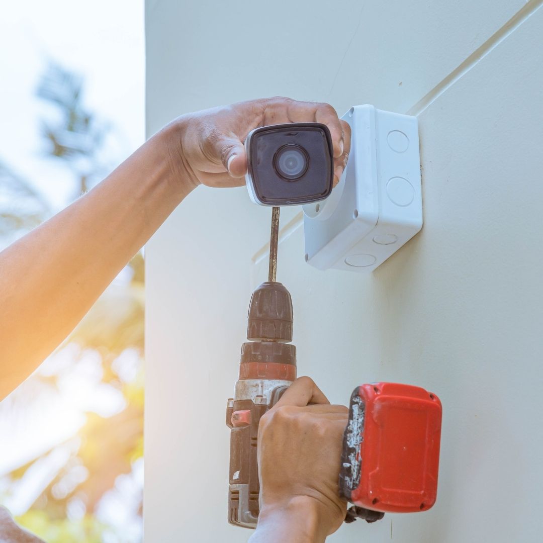 man installing security camera
