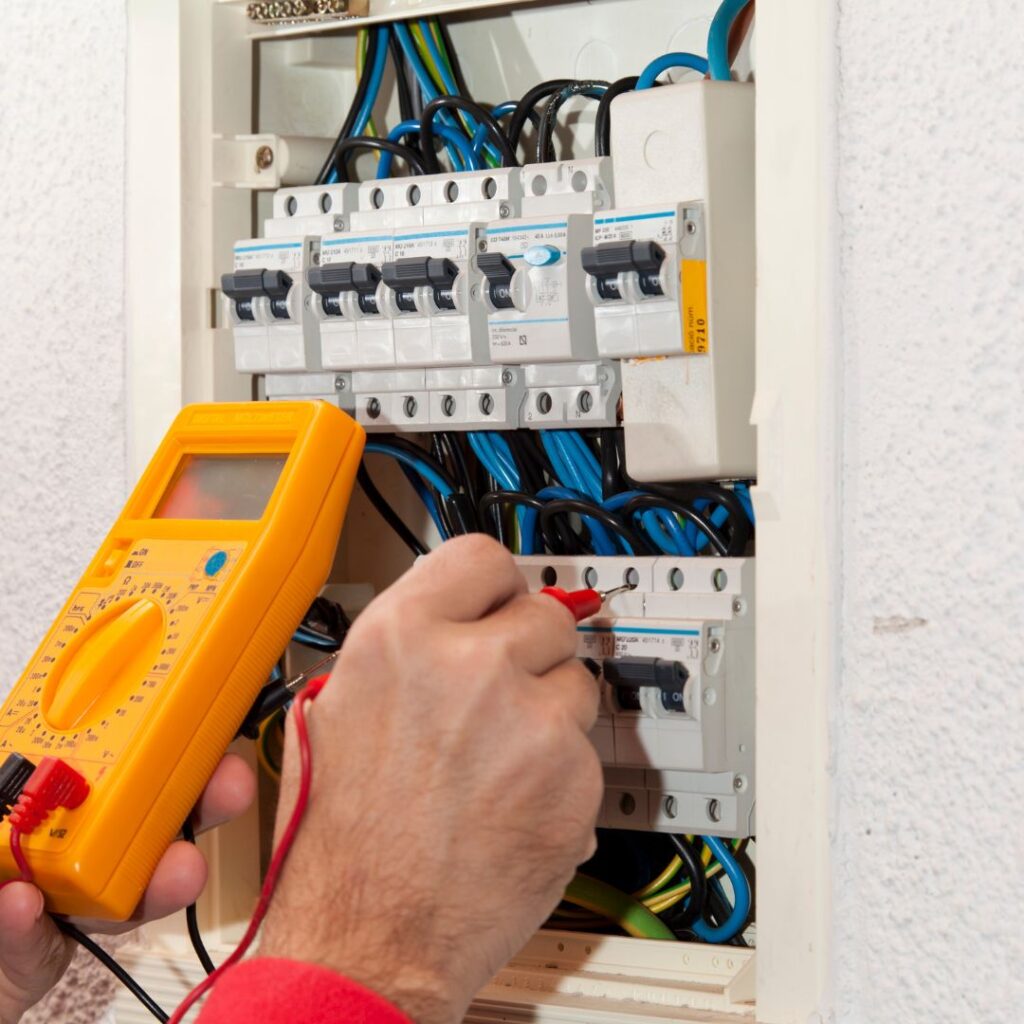 A closeup of a person testing the power levels in a electrical box
