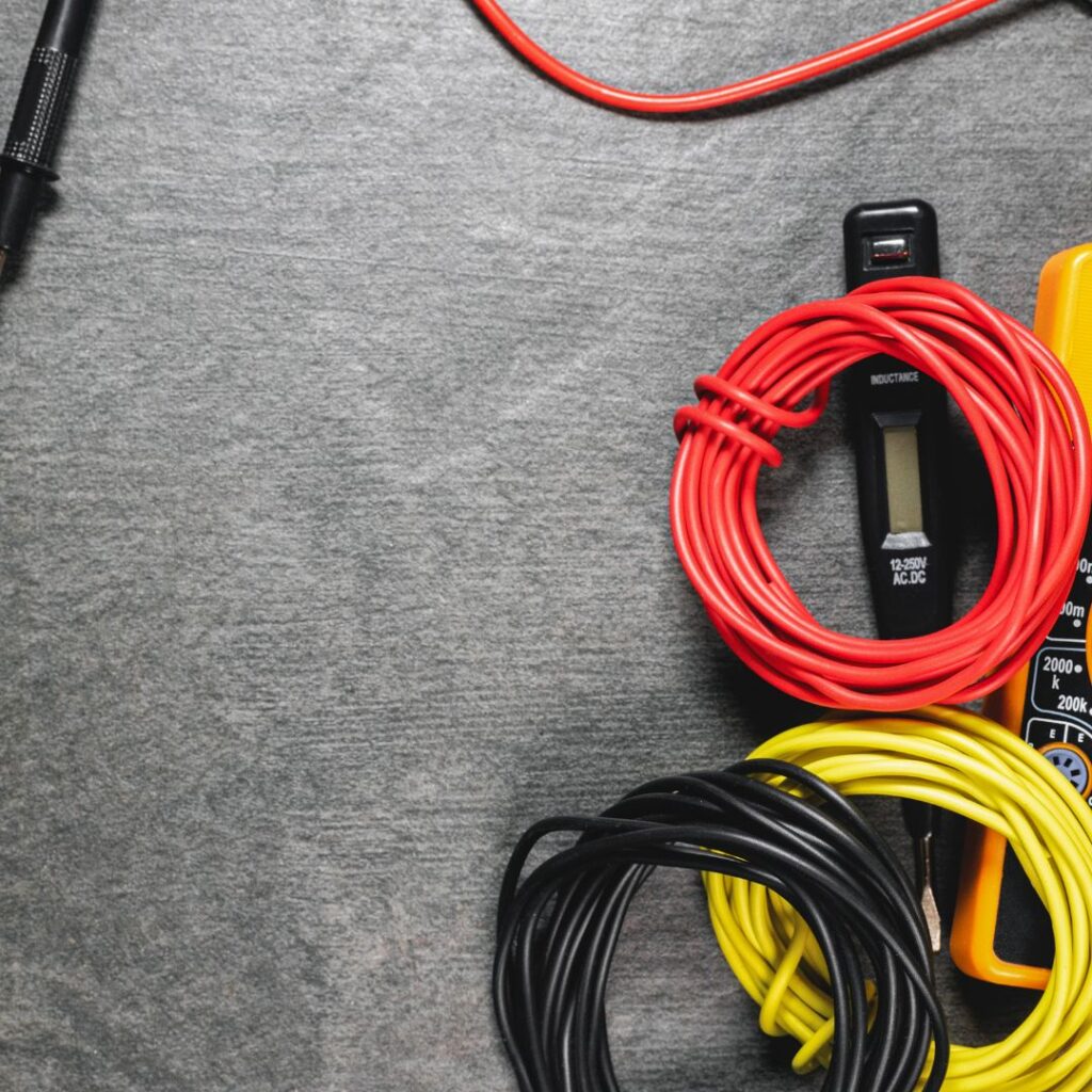 A black floor with different electrical supplies laying on it