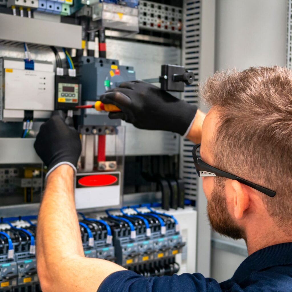 A man working on an electrical box