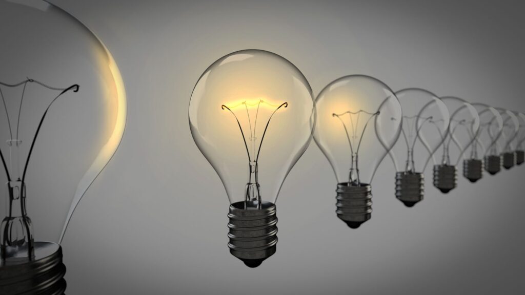 Black background with a line of lite up light bulbs