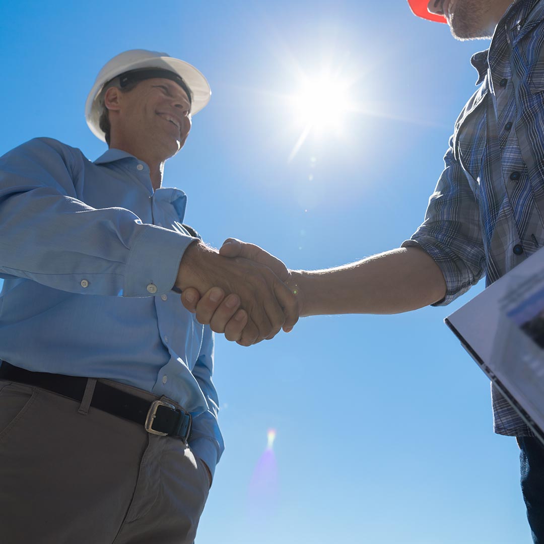 business man and electrician shaking hands
