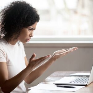 a woman looking upset at a computer